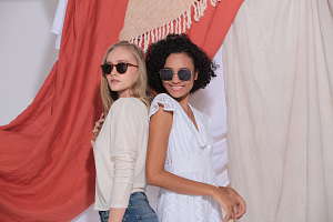 Two girls wearing polarized sunglasses