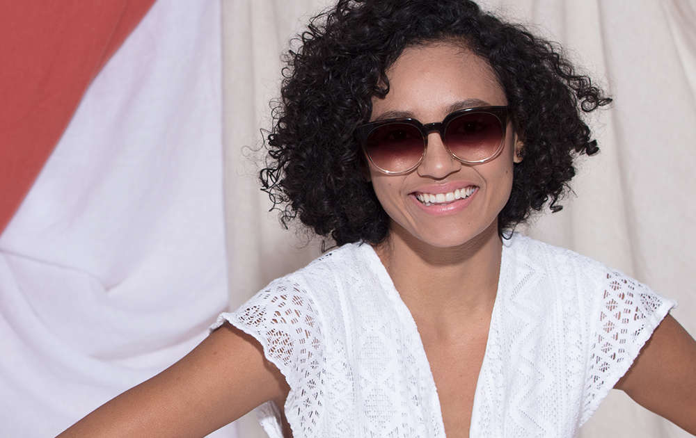 A woman wearing round sunglasses