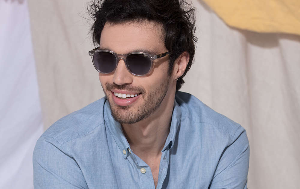 Man in blue shirt wearing polarized sunglasses