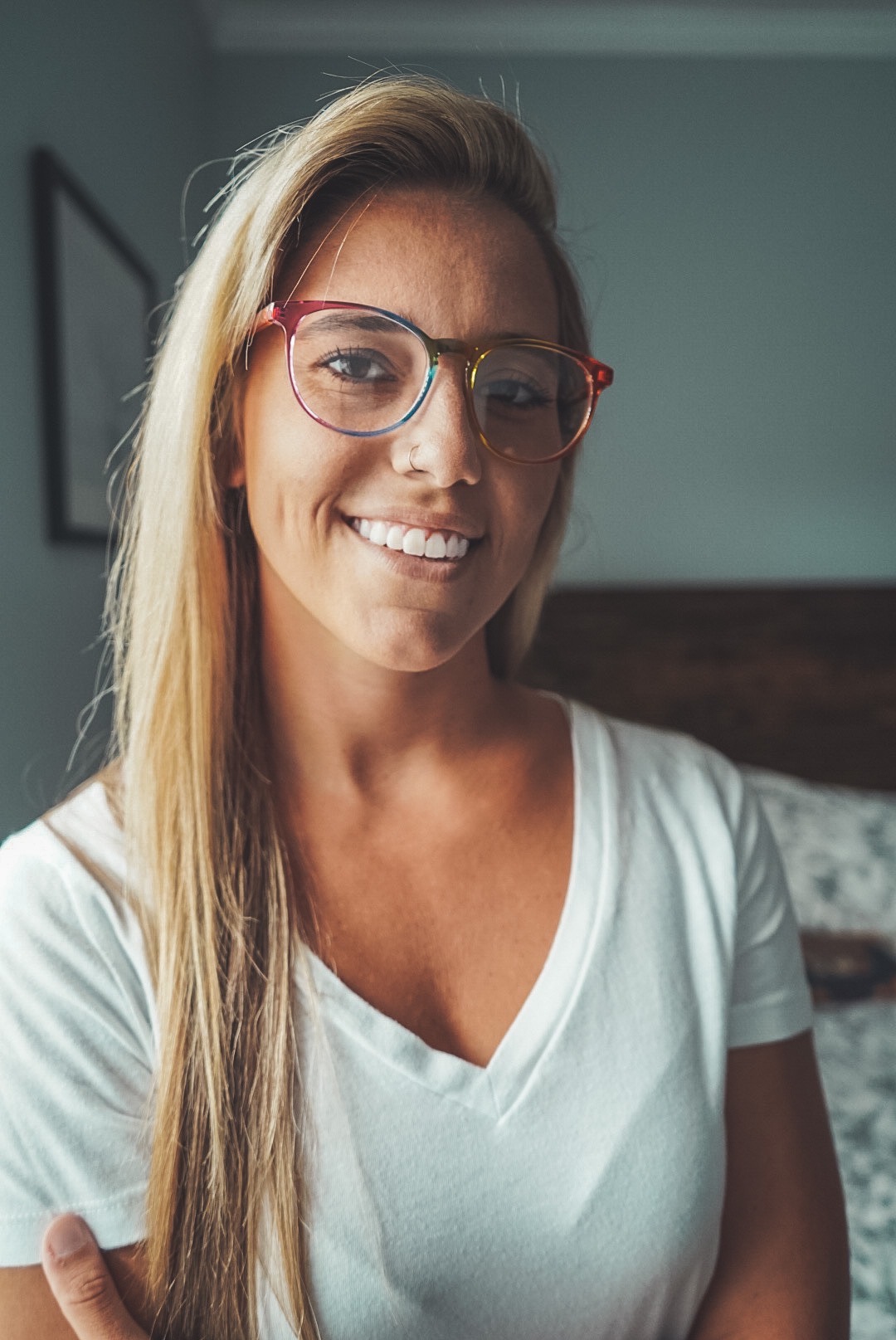 A person wearing rainbow-colored glasses