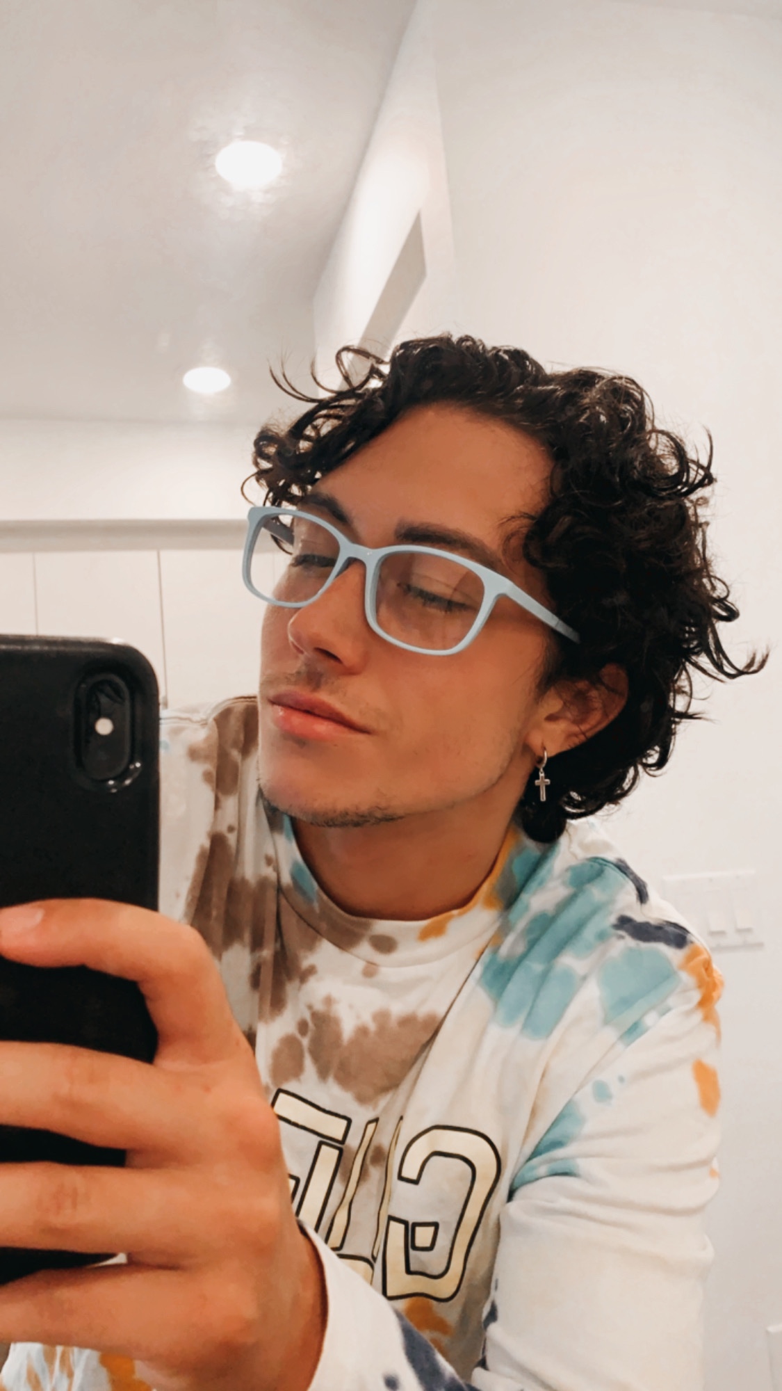 A person wearing light-blue glasses