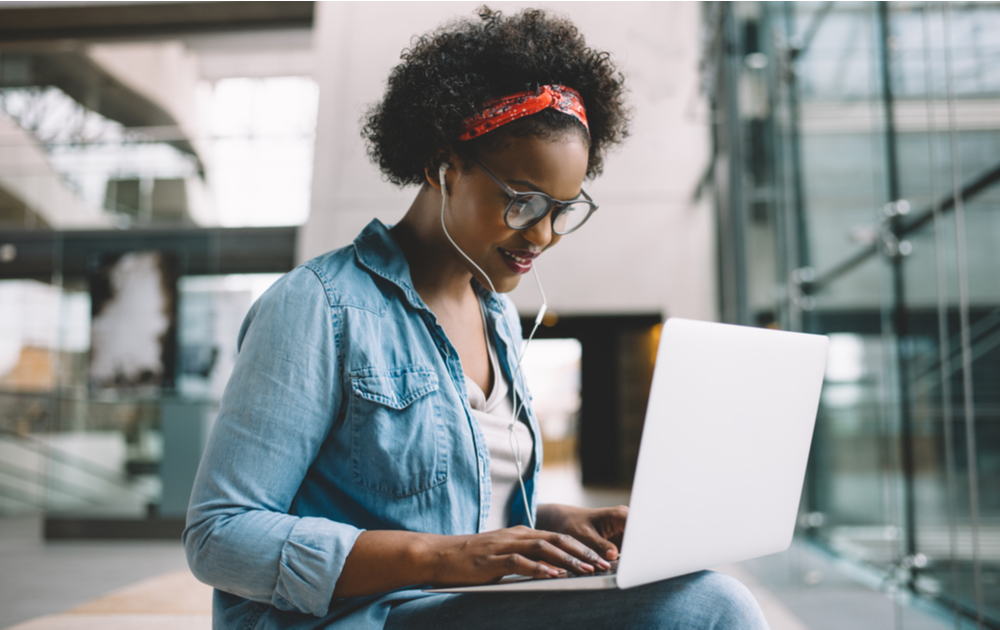 A woman using a laptop wearing blue light blocking glasses