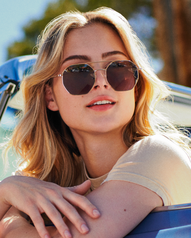 A woman with blonde hair wearing aviator sunglasses